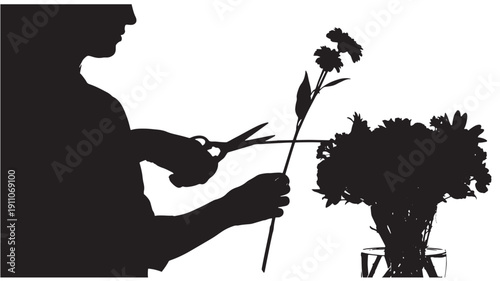 Silhouette of person cutting flower stem with scissors
