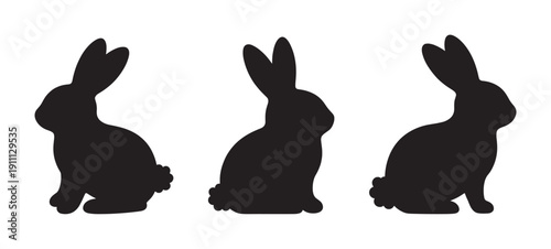 Three black rabbit silhouettes in profile view are depicted in a minimalist graphic style, showing the cute animals sitting with long ears and fluffy tails for an Easter theme