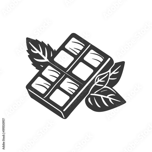 A dark chocolate bar with fresh mint leaves beside it