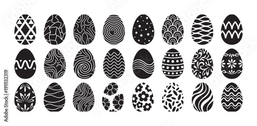 Large set of black Easter eggs with various white decorative patterns, including geometric, floral, and abstract designs, arranged in a grid for a festive holiday celebration