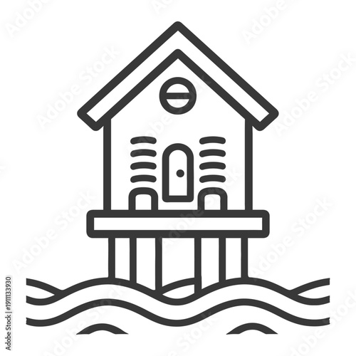 A small coastal house built on stilts above the water