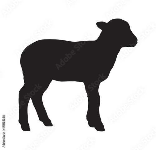 Black silhouette of a young lamb standing in profile, a simple and clean vector graphic illustration of a farm animal for agricultural or religious concepts