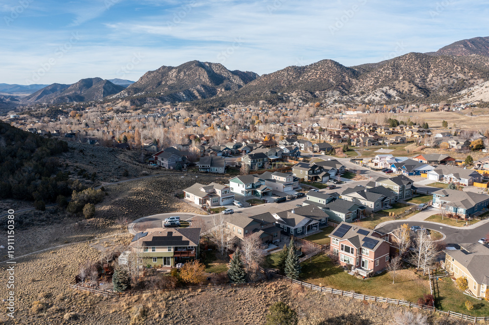 Obraz premium Aerial view of New Castle, Colorado residential area under sunny late autumn cloudscape.