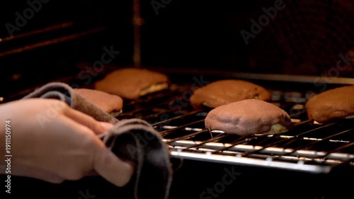 Freshly Baked Coffee Buns with Crispy Topping Cooling Inside a Warm Oven