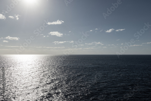 Schilderij op canvas Photo of beautiful endless wide shot of ocean horizon on bight sunny day at sea sun reflection on glassy calm ocean surface