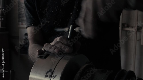 The entire scene in 8 clips: Different shots of a master carpenter working with wood in his workshop. Close-up shots of the woodworker along with the original sound track.