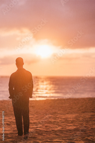 Young man enjoying solitude and inspiration on beach