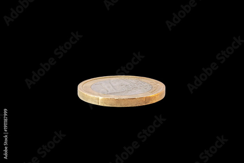 1 euro coin lying flat with the reverse side or tails view showing the face value with the European map design and edge detail, isolated on a black background.