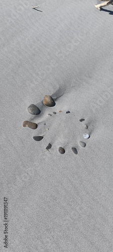 spiral shaped stones in the sand 