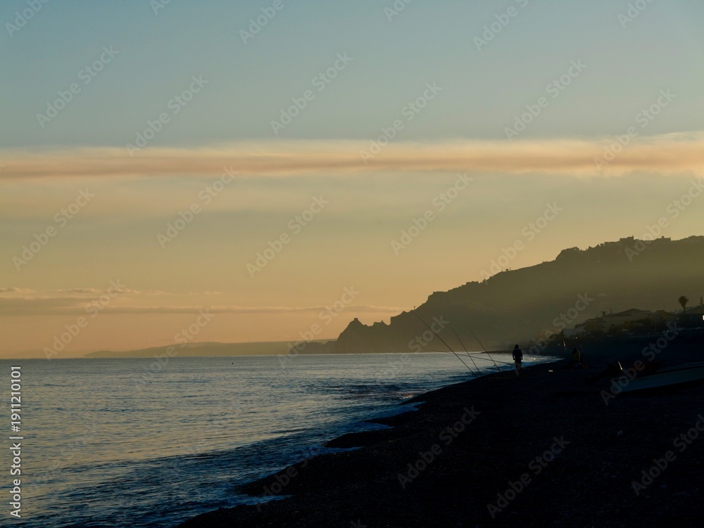 Obraz premium Sunset over the beach and coastline at Santa Teresa di Riva and Furci Siculo in January 2026, before Cyclone Harry, Sicily, Italy