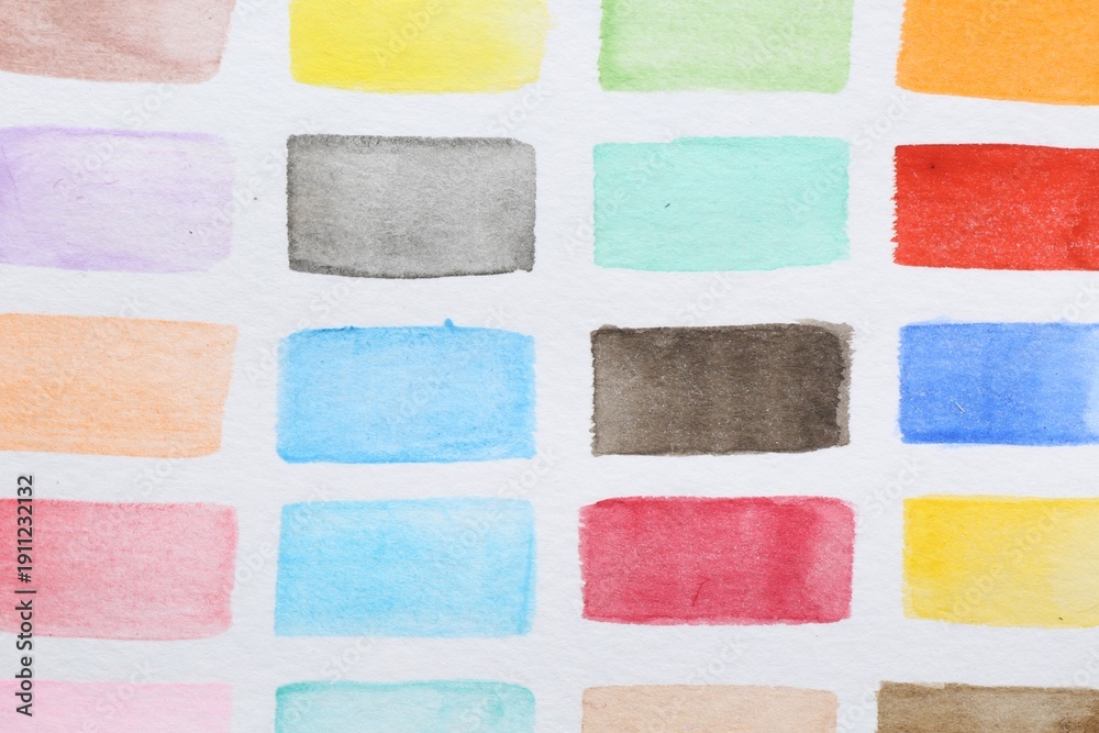 Fototapeta premium Painted watercolor strokes on white sheet of paper, top view