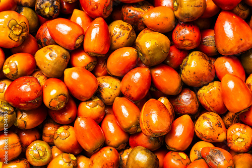 A close-up of ripe chontaduros stacked for sale in a traditional Colombian market, a staple of the local cuisine.