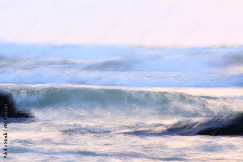 Obraz premium Long exposure abstract of waves at the beach during monsoon season