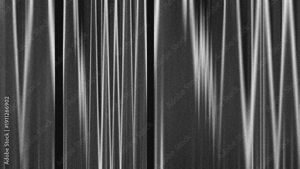 Fototapeta premium Abstract black and white grainy texture with vertical motion blur lines.