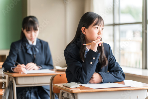 Canvas-taulu Female elementary, junior high, and high school students looking unmotivated out