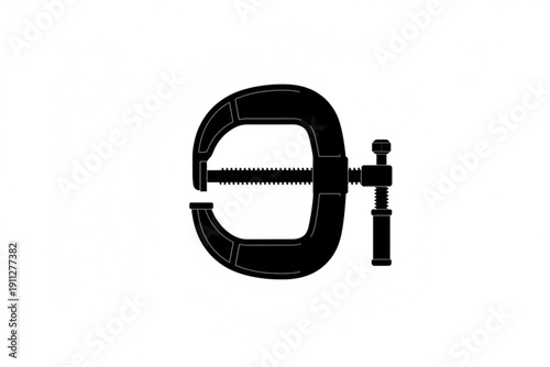 Precision Grip: A black clamp, silhouetted against a plain background, embodies the essence of precision and control. It's a testament to the power of tools.