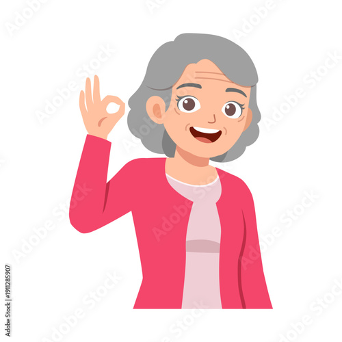 Happy smiling elderly woman making an OK gesture with her hand showing approval cheerful mood