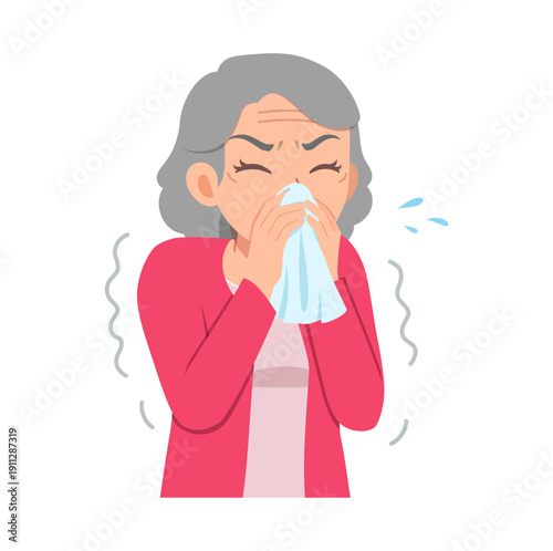 Elderly Asian woman with gray hair feeling unwell suffering from cold or allergy sneezing into a tissue