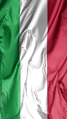 Vertical close-up of the national flag of Italy with realistic fabric texture and wavy folds. Detailed view of a green, white, and red Italian tricolor banner draped in elegant, flowing silk ripples f
