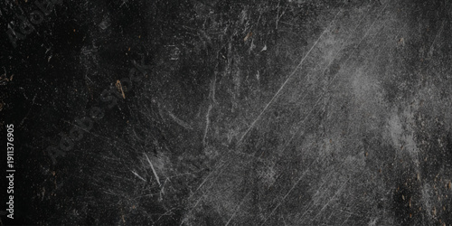 A textured dark gray background with subtle scratches and faint wispy markings throughout the frame
