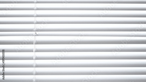 Close-up of white venetian blinds creating a pattern of horizontal lines and a sense of privacy