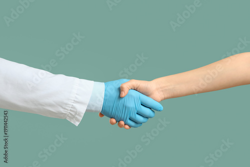 Doctor shaking hand of pati...