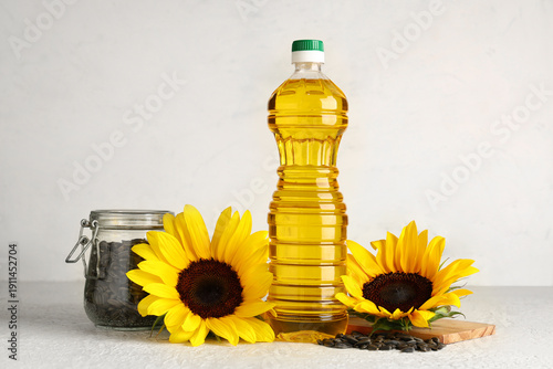 Bottle of oil, sunflowers a...