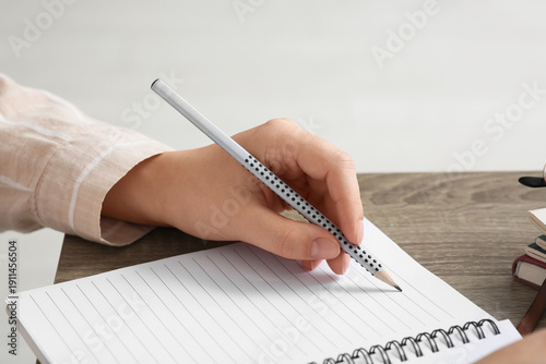 Woman writing something in ...