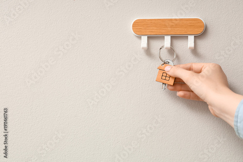 Female hand taking key from...
