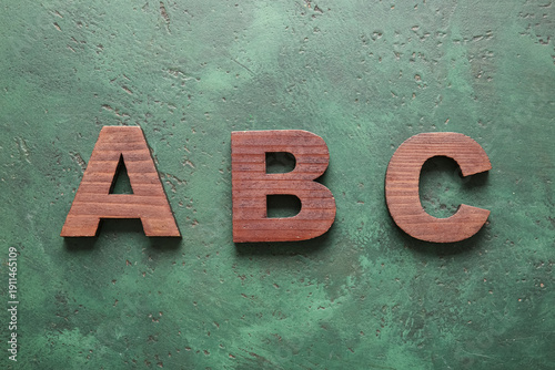 Letters A, B, C on green ba...