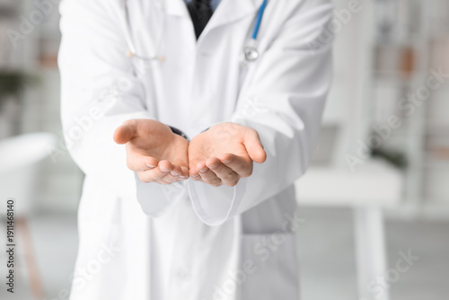 Male doctor holding somethi...