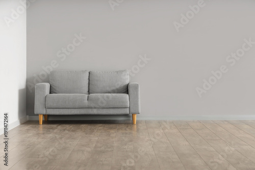 Sofa near grey wall in room