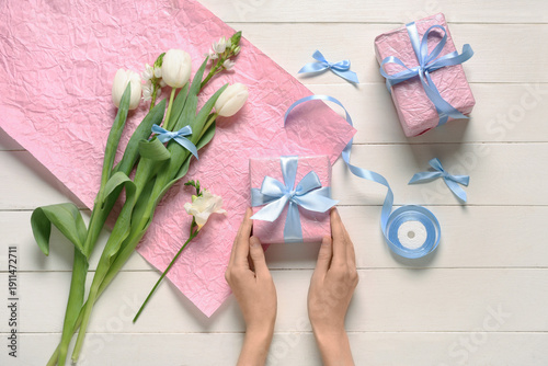 Female hands with gift boxe...