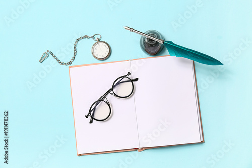 Open book with nib pen, ink...