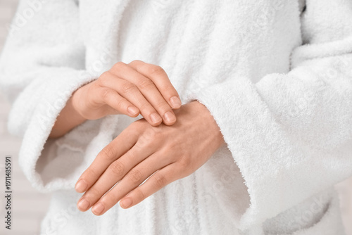 Young woman in bathrobe on ...