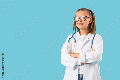 Cute doctor smiling on blue...