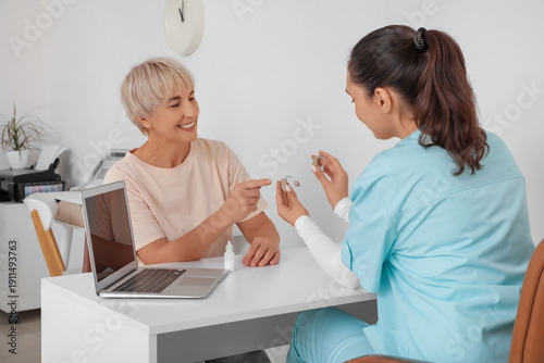 Mature woman choosing heari...