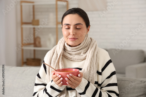 Sick young woman with soup ...