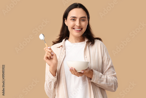 Young woman with tasty soup...