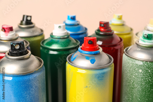 Many spray paint cans on be...