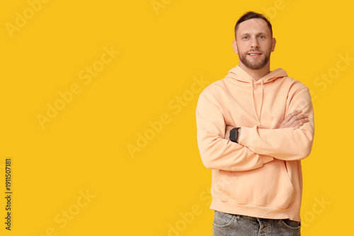 Stylish young man in hoodie...