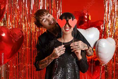 Young couple with paper hea...