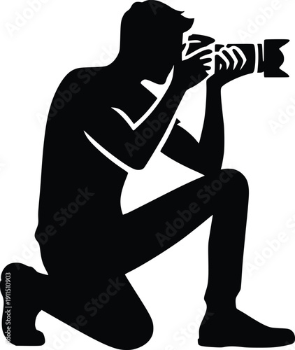 Silhouette of a photographer kneeling and taking a picture with a camera