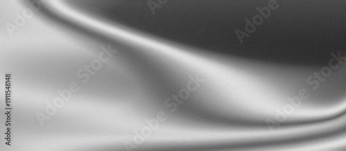 Soft gray satin fabric with smooth texture and subtle sheen in gentle folds creating a luxurious and elegant appearance for various design applications