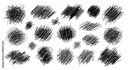 Collection of abstract black scribbles and marks on a clean surface viewed directly from above