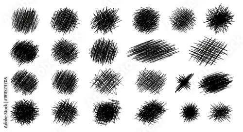 Collection of various black ink splatters and scribbles on a clean surface viewed from directly above