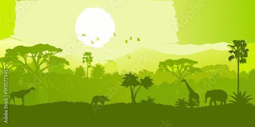 Silhouetted african savanna landscape with wildlife against a bright sun
