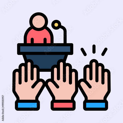 A person speaking at a podium with a microphone while multiple hands are raised in an audience, symbolizing participation or voting.