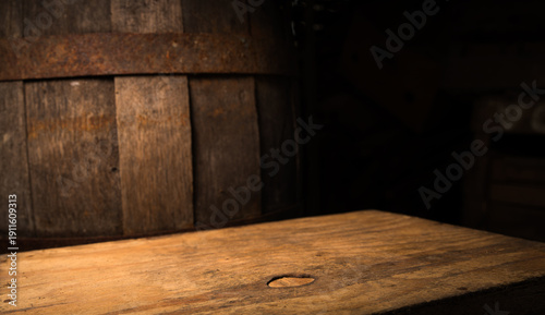 Vintage barrel backdrop with weathered table, soft warm light, rustic tavern atmosphere, textured wood planks and deep shadow