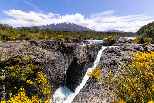 Puerto Varas, Chile: The famous Petrohue waterfall situated near Puerto Varas in Lake District of Chile with Osorno volcano covered with cloud on sunny day